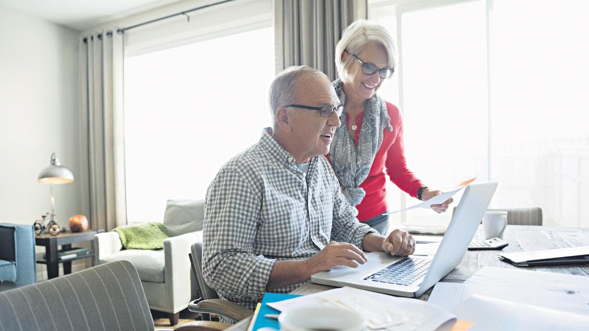 Senior couple reviewing their Medicare coverage options together at home