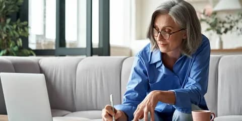 Woman reviewing Medicare Supplement plan options at her desk